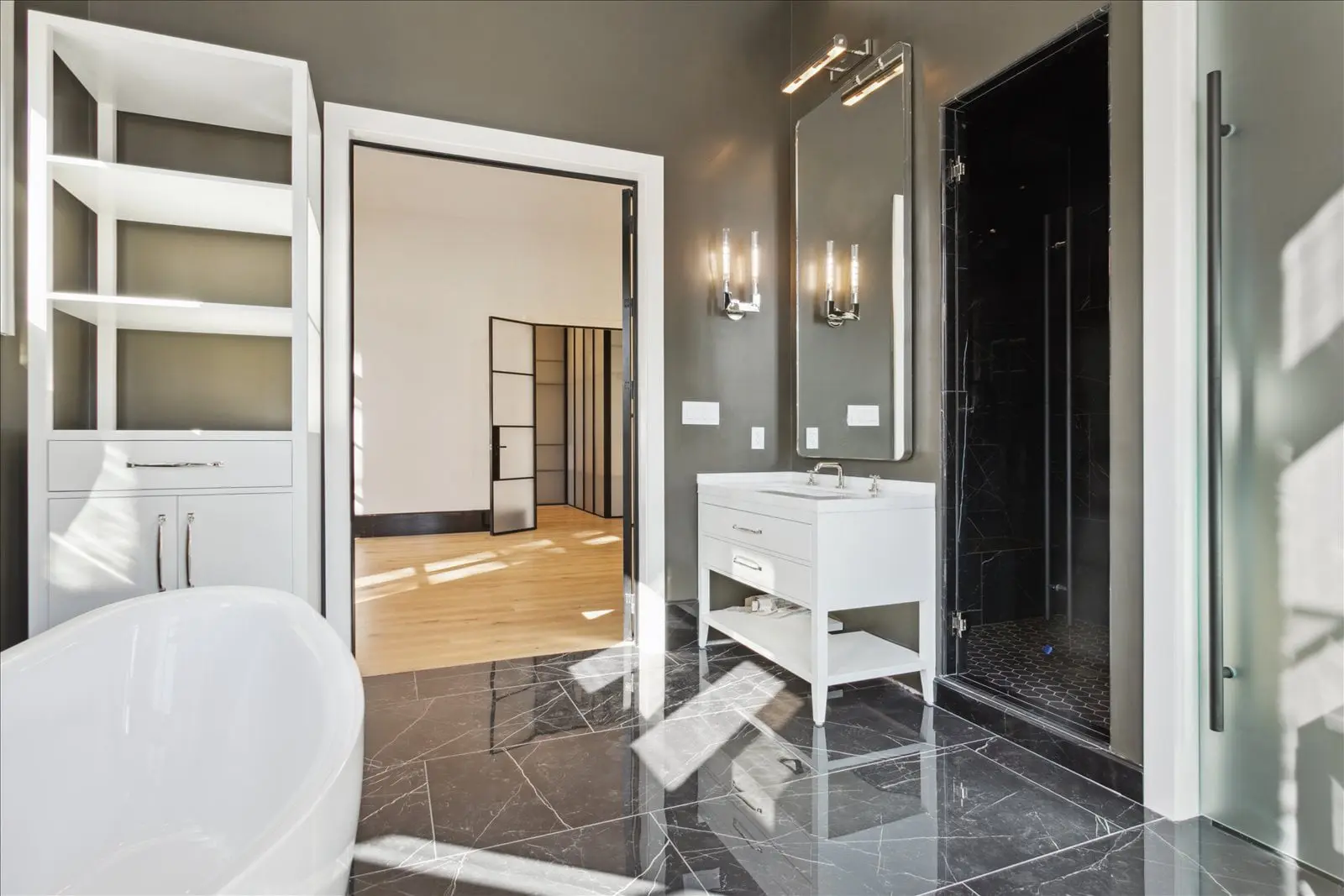 BAC bathroom with freestanding tub, vanity, shower, and stone flooring